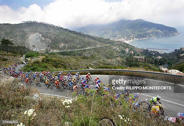 The pack rides through a coastal road during the twelve stage of Giro D'Italia cycling tour from Livorno to Sestri Levante, 19 May 2006. Spain's Joan...