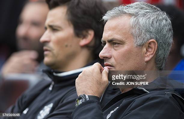 Manchester United's Portuguese manager Jose Mourinho watches his players ahead of the pre-season friendly football match between Wigan Athletic and...