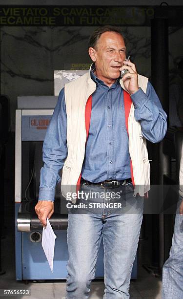 Football club Brescia' s coach Zdenek Zeman talks on the phone 19 May 2006 as he leaves the Public prosecutor's office in Naples. Zeman mets the...