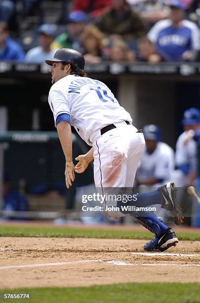 First baseman Doug Mientkiewicz of the Kansas City Royals runs to first base after hitting the ball during the game against the Cleveland Indians at...