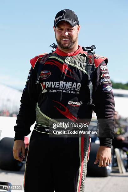 Eric Goodale, driver of the GAF Roofing/Supreme Skylights Chevrolet, stands on the grid during qualifying for the NASCAR Whelen Modified Tour New...