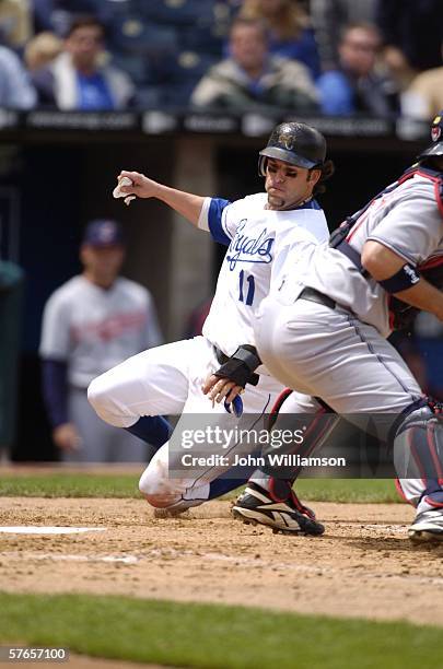 First baseman Doug Mientkiewicz of the Kansas City Royals slides home to score a run during the game against the Cleveland Indians at Kauffman...