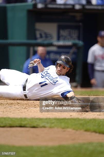 First baseman Doug Mientkiewicz of the Kansas City Royals slides home to score a run during the game against the Cleveland Indians at Kauffman...