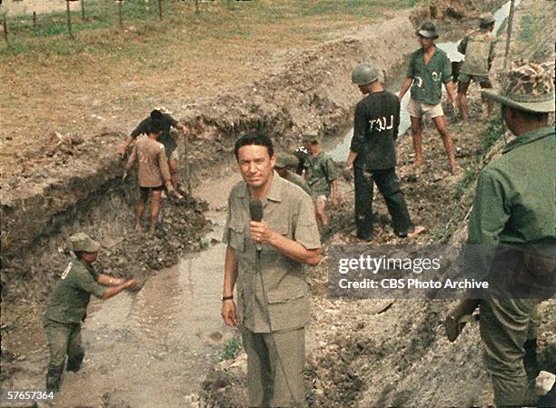 American TV news correspondent Mike Wallace of CBS News reports from a trench during the Vietnam War, 1967.