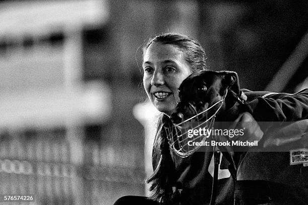 Race steward and greyhound at Wentworth Park on July 16, 2016 in Sydney, Australia. Greyhound Racing in NSW has now resumed after a week suspension....