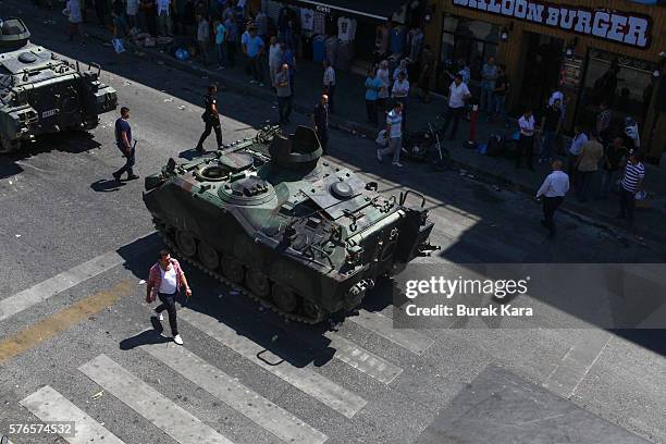 People walk past a Turkish army's abandoned tank in Uskudar district July 16, 2016 in Istanbul, Turkey. Istanbul's bridges across the Bosphorus, the...