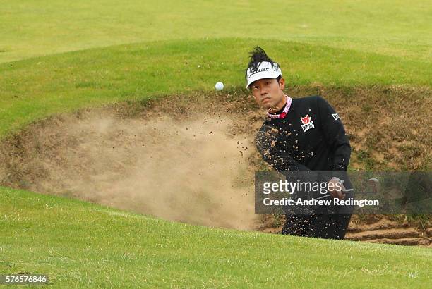 Kevin Na of the United States plays a shot from a bunker on the 4th hole during the third round on day three of the 145th Open Championship at Royal...