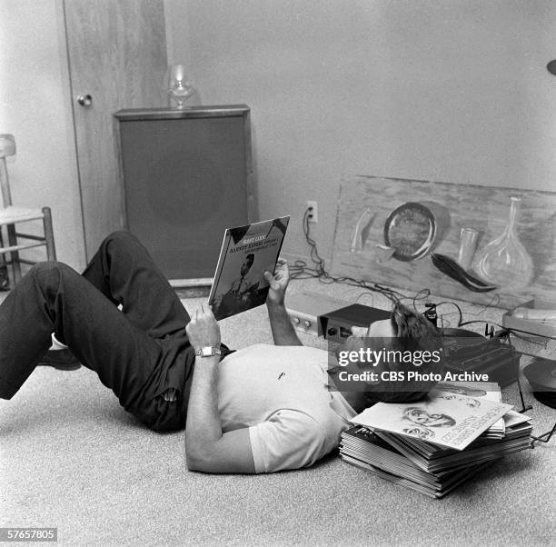 American actor Clint Eastwood listens to records at his home, October 1, 1959.