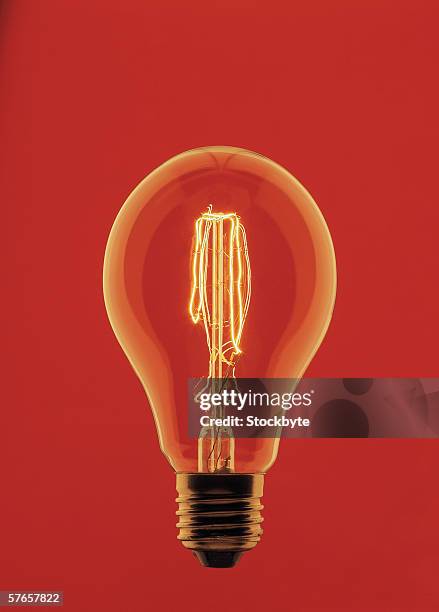 close-up of a light bulb with its filament glowing - infrared lamp stockfoto's en -beelden