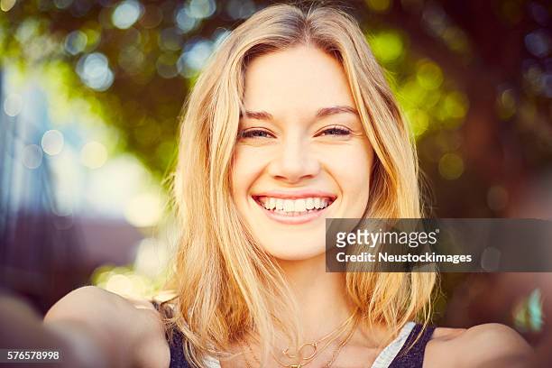 point of view of beautiful blond woman taking selfie - blonde woman selfie stock pictures, royalty-free photos & images