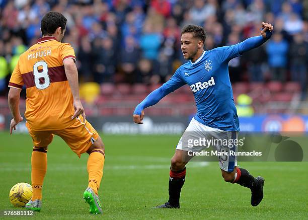 Harry Forrester of Rangers takes on Carl McHugh of Motherwell during the Scottish League Cup First Round Group Stage match between Motherwell FC and...