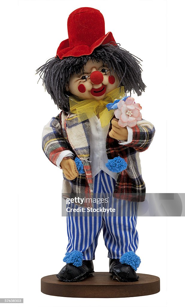 Wooden clown holding a flower