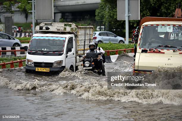 Vehicles wade through the water-logged road near AIIMS flyover after overnight rain, on July 16, 2016 in New Delhi, India. Overnight and morning rain...