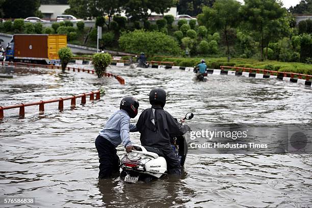 Vehicles wade through the water-logged road near AIIMS flyover after overnight rain, on July 16, 2016 in New Delhi, India. Overnight and morning rain...