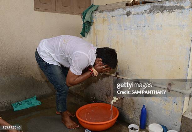 Indian convenor of the Patidar Anamat Andolan Samiti movement Hardik Patel bathes at his home in Viramgam, some 60 kms from Ahmedabad, on July 16,...