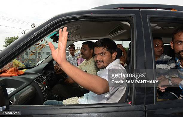 Indian convenor of the Patidar Anamat Andolan Samiti movement Hardik Patel waves from a car as he leaves his home town Viramgam, some 60 kms from...