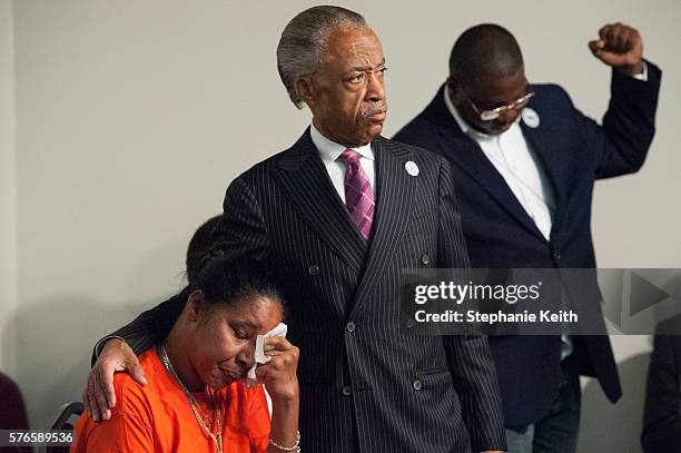 Eric Garner's widow, Esaw Garner is comforted by Al Sharpton at the National Action Network headquarters at an event commemorating the two year...