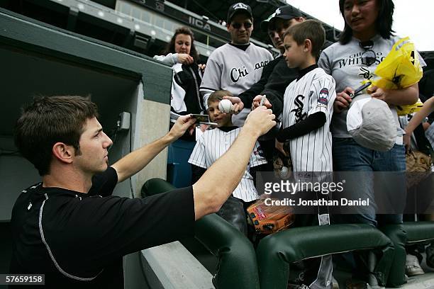 Pitcher Jon Garland of the Chicago White Sox signs autographs for fans before a game against the Chicago Cubs on May 19, 2006 at U.S. Cellular Field...