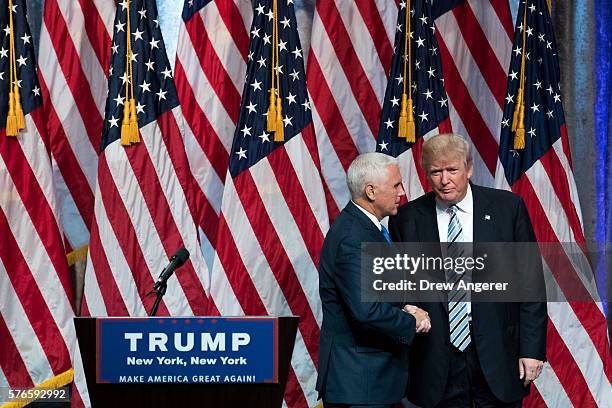 Republican presidential candidate Donald Trump stands with his newly selected vice presidential running mate Mike Pence , governor of Indiana, at the...