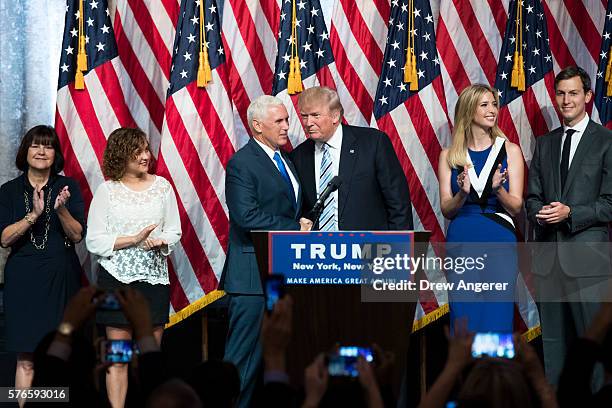 Surrounded by family members, Republican presidential candidate Donald Trump stands with his newly selected vice presidential running mate Mike...