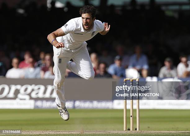 England's Steven Finn bowls a ball on the third day of the first Test cricket match between England and Pakistan at Lord's cricket ground in London,...