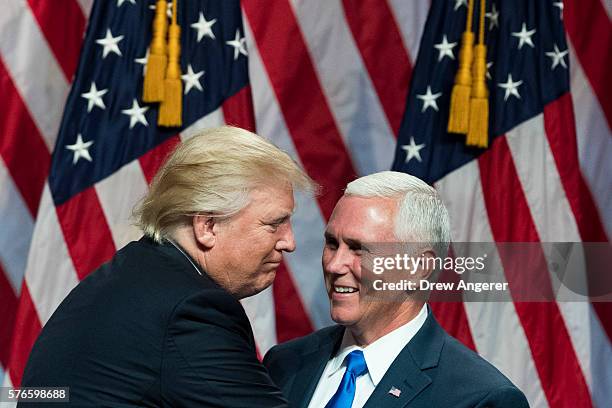 Republican presidential candidate Donald Trump greets his newly selected vice presidential running mate Mike Pence, governor of Indiana, as he takes...