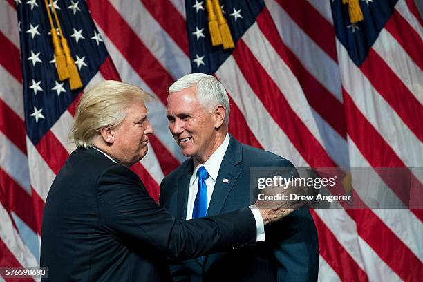 Republican presidential candidate Donald Trump greets his newly selected vice presidential running mate Mike Pence, governor of Indiana, as he takes...