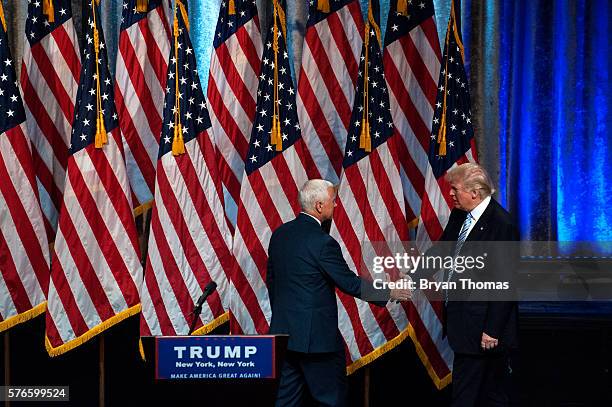 Republican presidential candidate Donald Trump, right, shakes hands with his vice presidential running mate Indiana Gov. Mike Pence, left, at the New...
