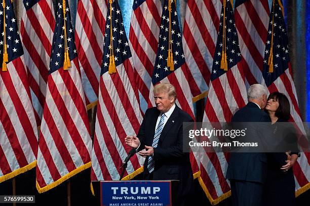 Republican presidential candidate Donald Trump, left, claps as his vice presidential running mate Indiana Gov. Mike Pence, right, kisses his wife at...
