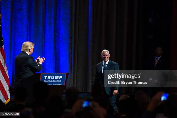 Republican presidential candidate Donald Trump, left, introduces his vice presidential running mate Indiana Gov. Mike Pence, right, at the New York...