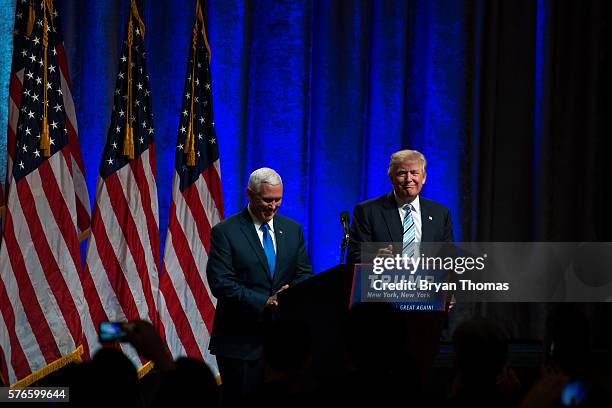 Republican presidential candidate Donald Trump, right, introduces his vice presidential running mate Indiana Gov. Mike Pence, left, at the New York...