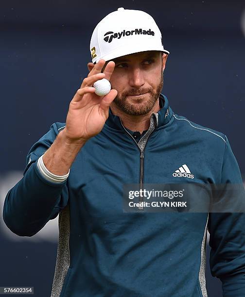 Golfer Dustin Johnson reacts on the 18th green after his third round 72 on day three of the 2016 British Open Golf Championship at Royal Troon in...