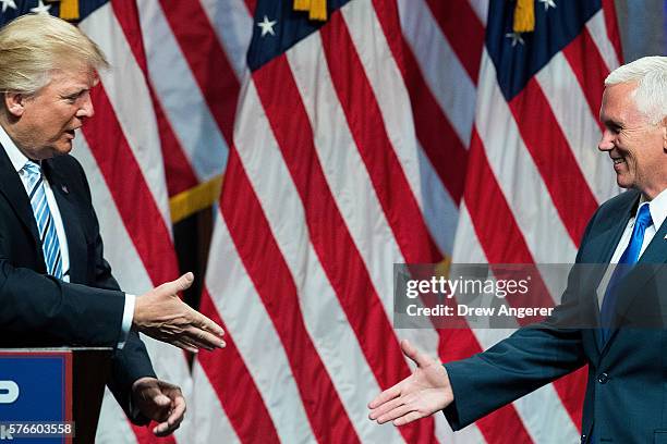 Republican presidential candidate Donald Trump prepares to shake hands with his newly selected vice presidential running mate Mike Pence, governor of...