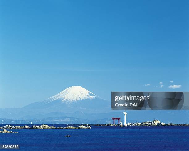 mt. fuji from hayama beach - torii tor stock-fotos und bilder