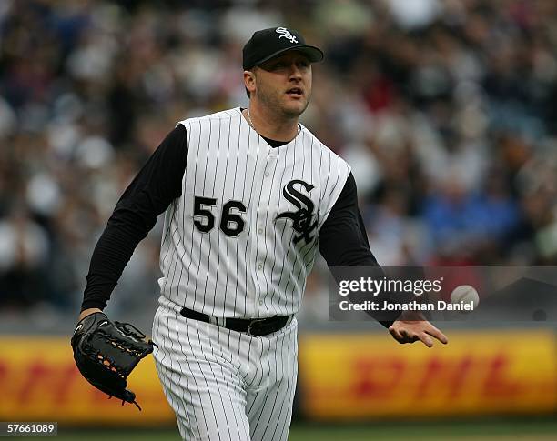 Mark Buehrle of the Chicago White Sox flips the ball to first baseman Paul Konerko for an out against Jerry Hairston of the Chicago Cubs May 19, 2006...