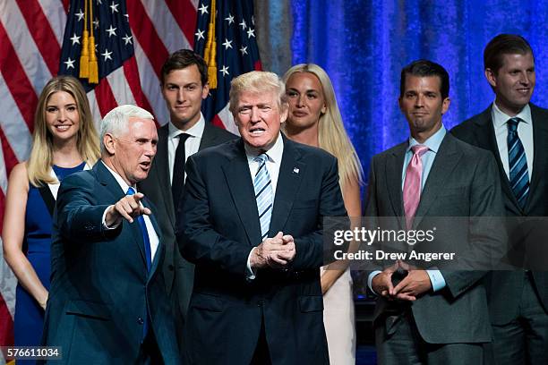 Newly selected vice presidential running mate Mike Pence, governor of Indiana, stands onstage with Republican presidential candidate Donald Trump and...