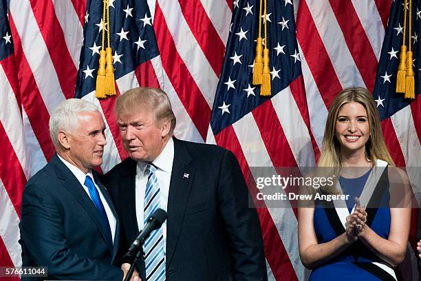 Newly selected vice presidential running mate Mike Pence, governor of Indiana, stands with Republican presidential candidate Donald Trump as Ivanka...