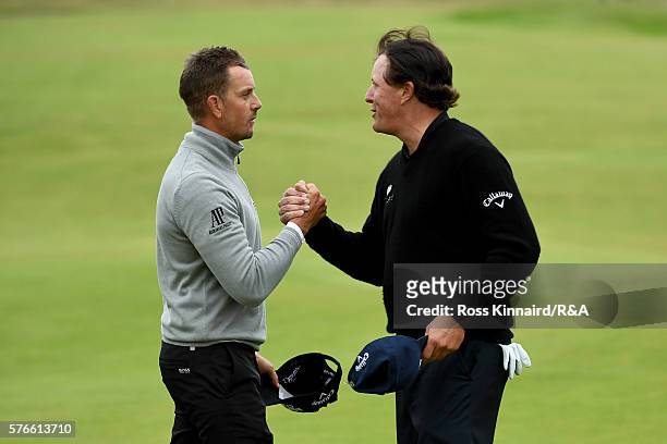 Phil Mickelson of the United States shakes hands with Henrik Stenson of Sweden on the 18th green during the third round on day three of the 145th...