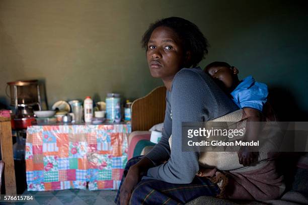 Mathato Notsi is in a pensive mood after giving with her ten month old baby Mpho his morning dose of his anti retroviral medication.. Mathato...