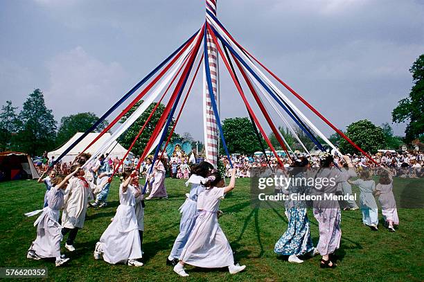 children dancing around maypole - maypole stock-fotos und bilder