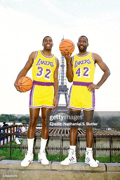 Earvin "Magic" Johnson and James Worthy of the Los Angeles Lakers pose for a portrait with the Eiffel Tower in the background circa 1991 in Paris,...