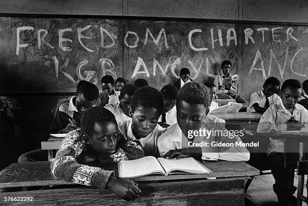 students sharing textbook in class - soweto stock pictures, royalty-free photos & images