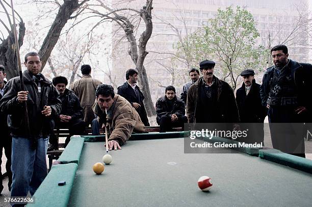 men playing billiards outside in azerbaijan - baku stock pictures, royalty-free photos & images