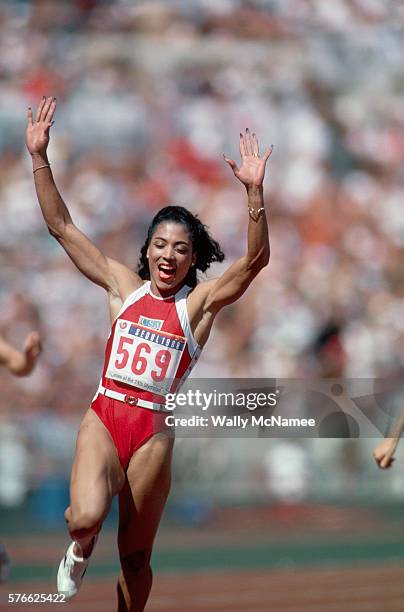 Track and field runner Florence Griffith Joyner celebrates as she places first in a race, winning a gold medal at the 1988 Olympics in Seoul, Korea.