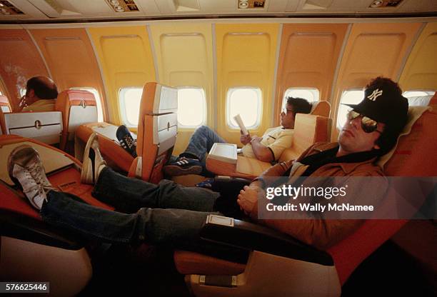 Singer and pianist Billy Joel rests on an airline flight between Austin and Dallas during a tour promoting his "57th Street" album. | Location: Above...