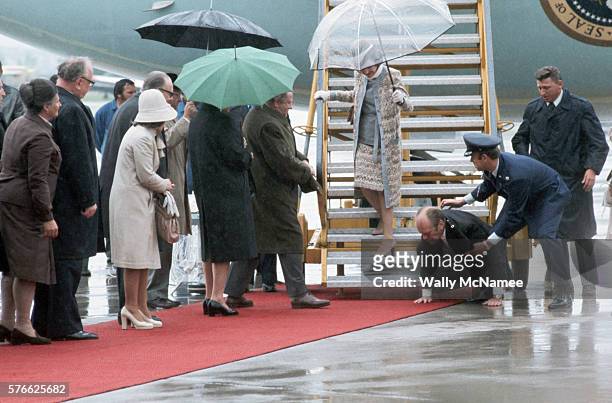 President Ford is helped to his feet after he slipped and fell as he was deplaning Air Force One.