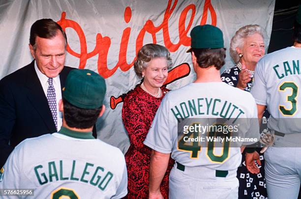 President George Bush, Queen Elizabeth II and First Lady Barbara Bush shake hands with Mike Gallego, Rick Honeycutt, and Jose Canseco of the Oakland...