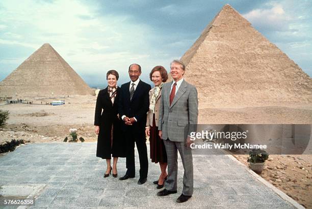 Egyptian president Anwar al-Sadat and his wife Jehan pose with President Jimmy Carter and First Lady Rosalynn Carter at the Pyramids, during a...