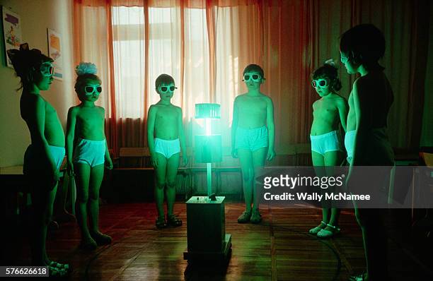 Young girls wearing undershorts and protective glasses undergo light deprivation treatment at their school in Stavropol, USSR. Strong full-spectrum...