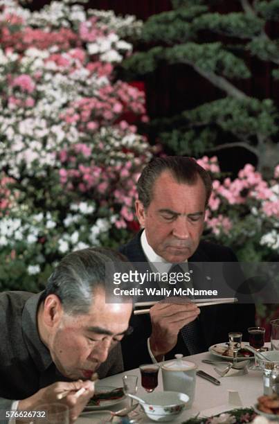 President Richard Nixon considers the taste of a Chinese appetizer at an official banquet at the Great Hall of the People during Nixon's historic...